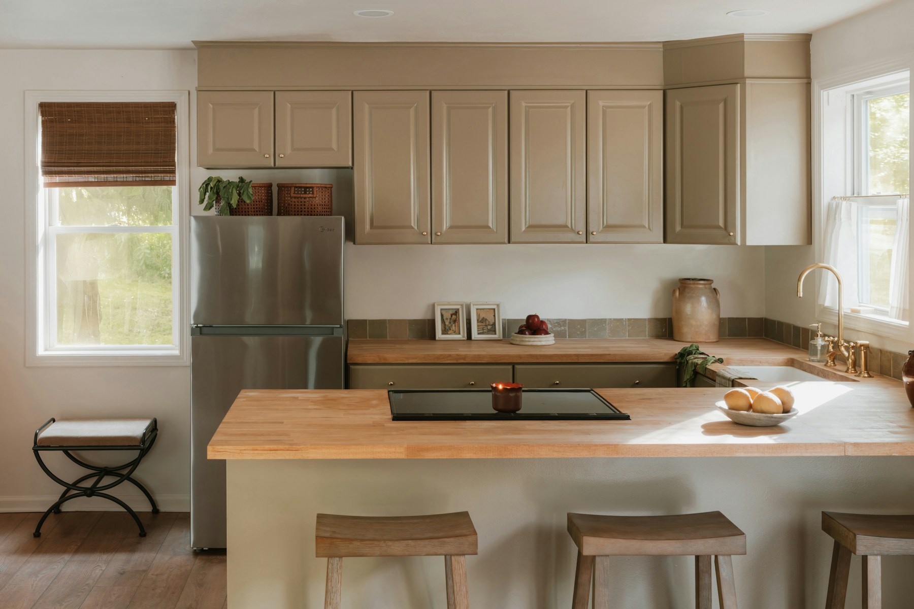 Black oak cabinetry with a pale stone island